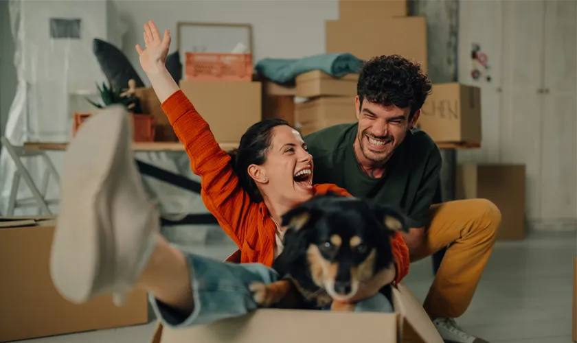 Discount (Couple and dog play moving boxes) | US Heating & Air